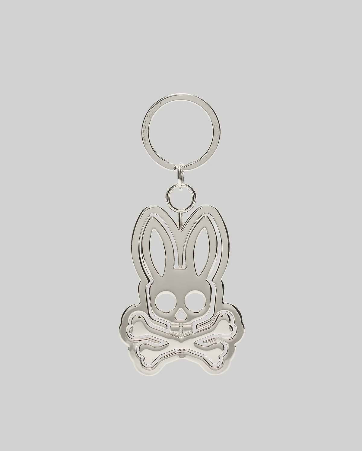 Silver metallic Spinning Bunny Keychain featuring the iconic Psycho Bunny skull and crossbones logo design with a hollowed-out center, attached to a classic key ring.