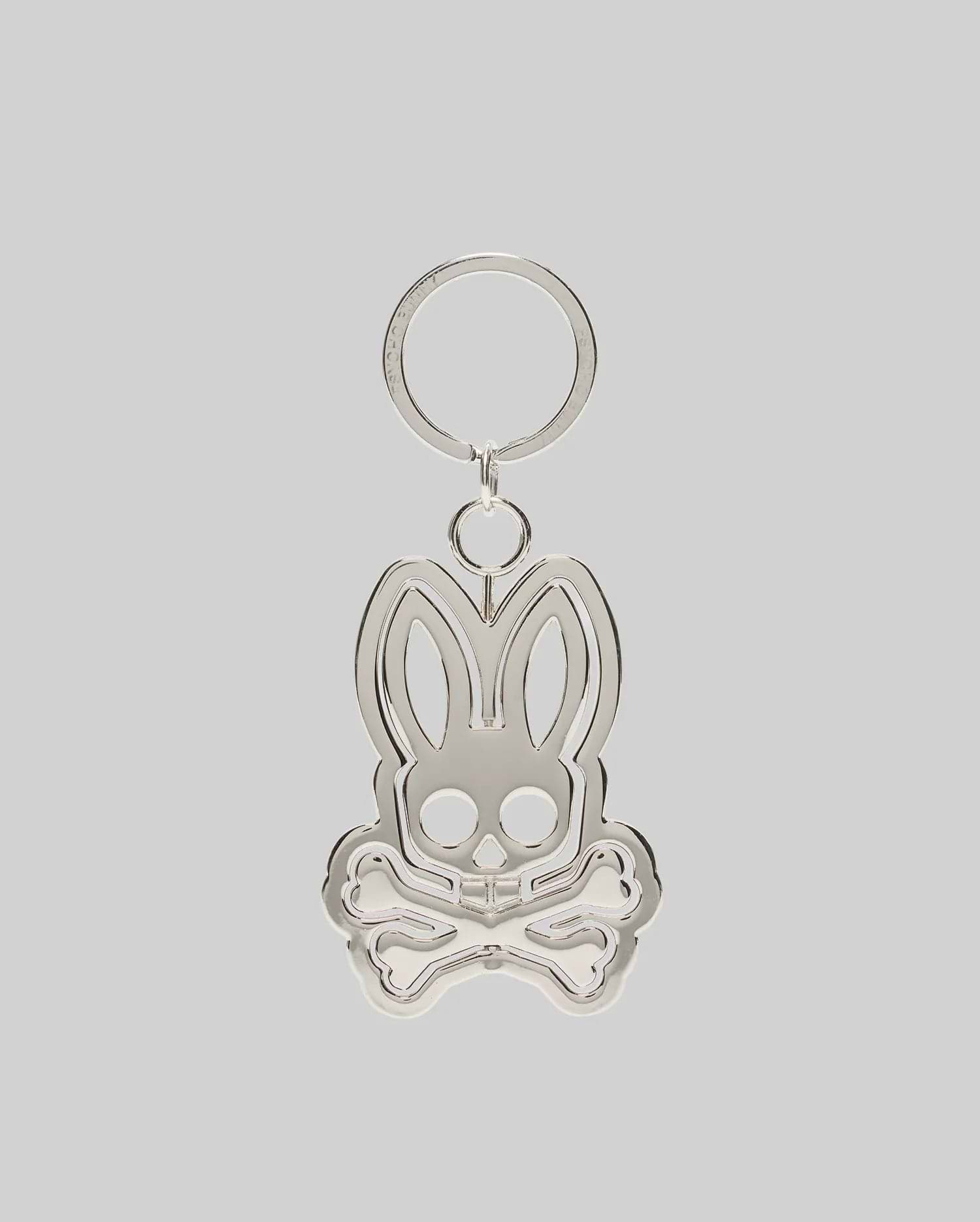 Silver metallic Spinning Bunny Keychain featuring the iconic Psycho Bunny skull and crossbones logo design with a hollowed-out center, attached to a classic key ring.