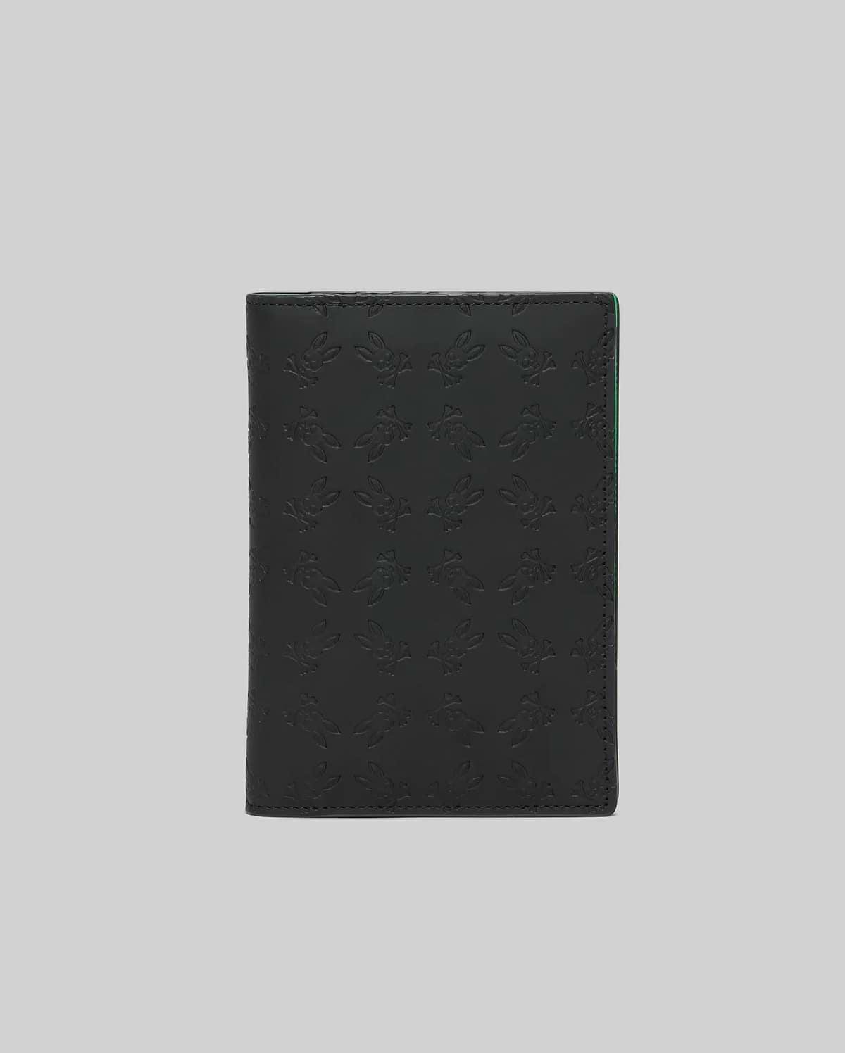 Black Passport Holder with an all-over embossed Psycho Bunny skull logo pattern and subtle green accent on the interior edge, crafted from smooth, premium material. (2)