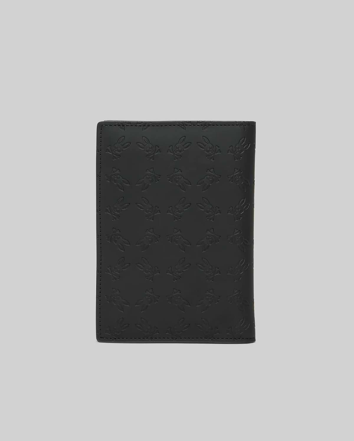 Black Passport Holder featuring a refined, all-over embossed Psycho Bunny skull logo pattern on its smooth, premium leather-like surface, showcasing distinctive brand identity. (4)