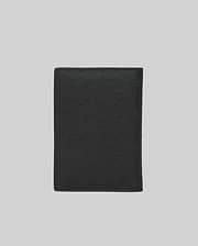 Black Passport Holder featuring a refined, all-over embossed Psycho Bunny skull logo pattern on its smooth, premium leather-like surface, showcasing distinctive brand identity. (4)