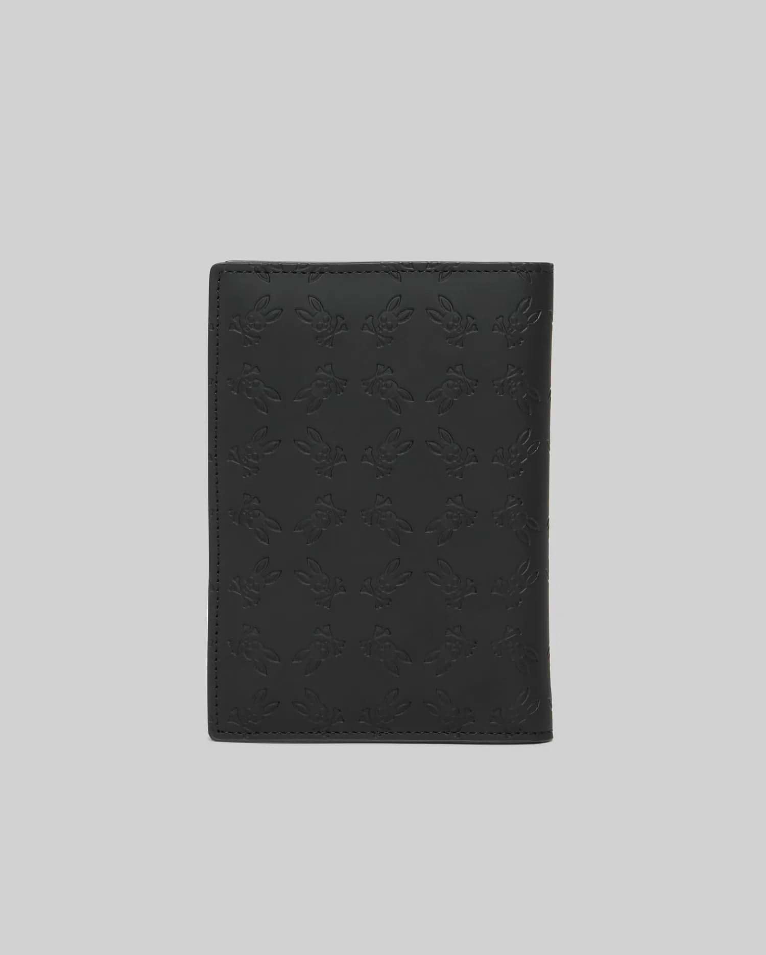Black Passport Holder featuring a refined, all-over embossed Psycho Bunny skull logo pattern on its smooth, premium leather-like surface, showcasing distinctive brand identity. (4)