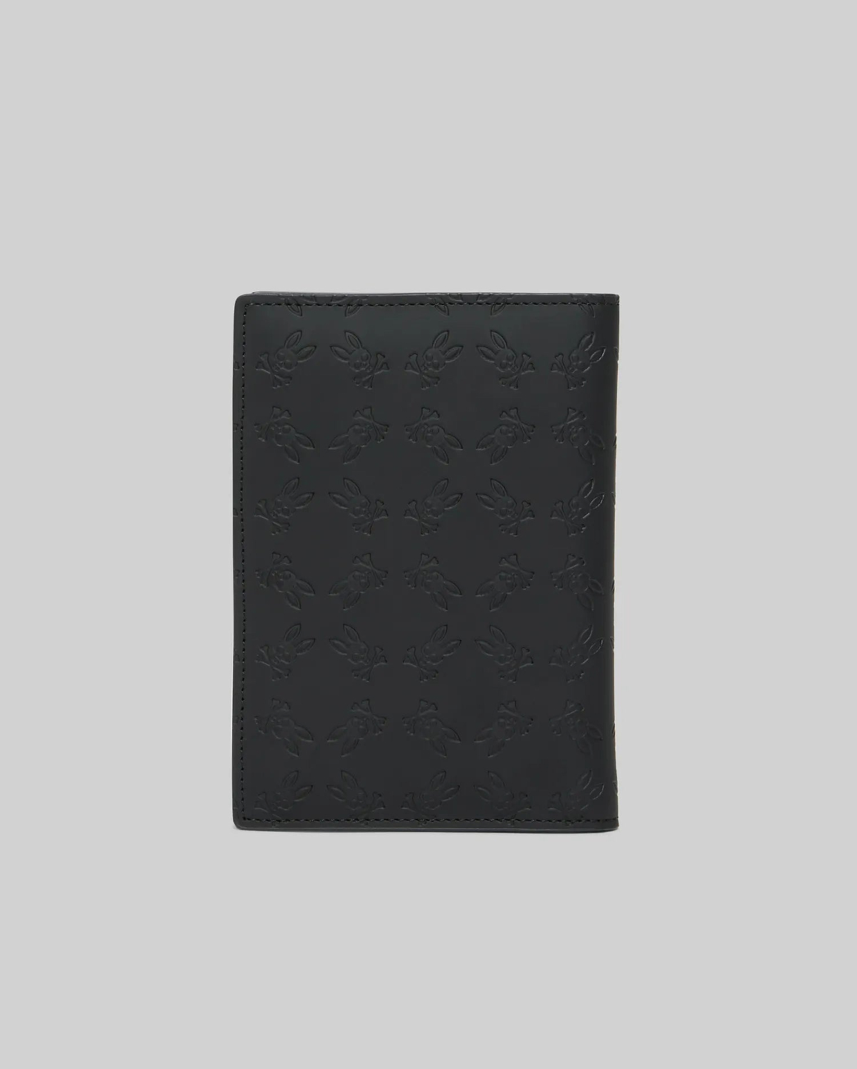 Black Passport Holder featuring a refined, all-over embossed Psycho Bunny skull logo pattern on its smooth, premium leather-like surface, showcasing distinctive brand identity. (4)