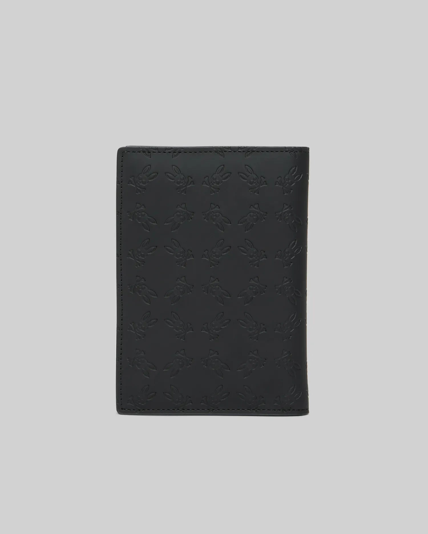 Black Passport Holder featuring a refined, all-over embossed Psycho Bunny skull logo pattern on its smooth, premium leather-like surface, showcasing distinctive brand identity. (4)