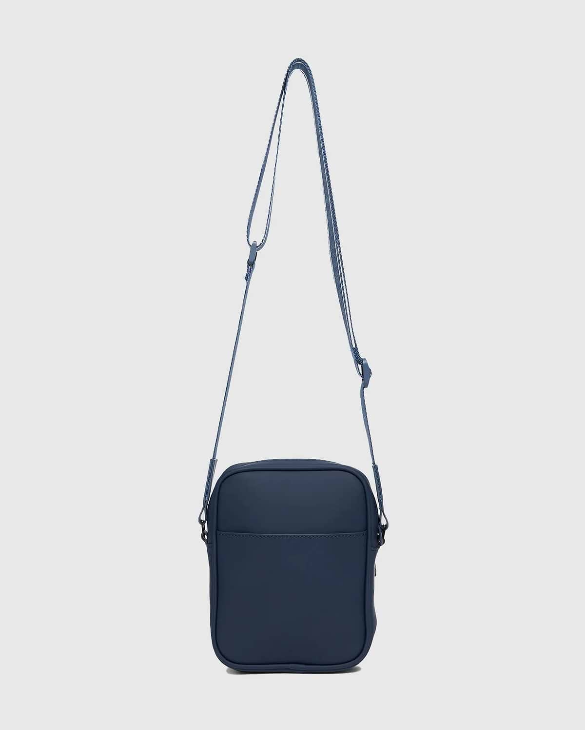 CLASSIC BUNNY MESSENGER BAG in deep navy blue, featuring a smooth, matte finish, front slip pocket, and an adjustable woven strap with subtle white accent stripes.