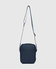CLASSIC BUNNY MESSENGER BAG in deep navy blue, featuring a smooth, matte finish, front slip pocket, and an adjustable woven strap with subtle white accent stripes.