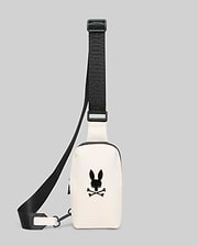 Mens Rubberized Crossbody in cream, featuring a smooth finish, a prominent black Psycho Bunny skull logo on the front, and an adjustable black strap with repeated brand text.