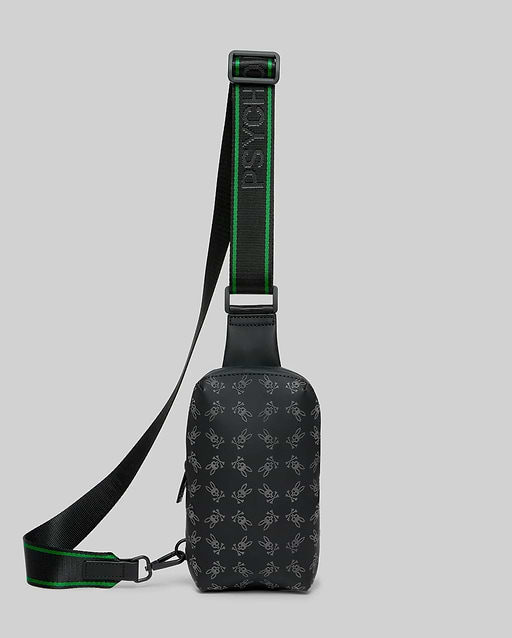 Mens Rubberized Crossbody in black, featuring an all-over subtle grey Psycho Bunny skull logo pattern and a black woven strap with bold green stripes and repeated Psycho Bunny text.