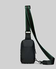 Mens Rubberized Crossbody in black, featuring a subtle all-over bunny skull pattern, a prominent green-striped strap with PSYCHO BUNNY text, and a sleek, compact design.