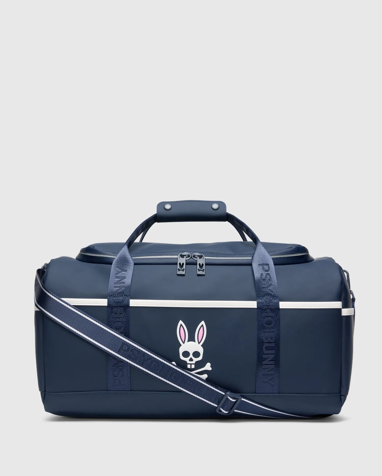 Smooth, durable navy blue Classic Bunny Gym Bag with a large white and pink Psycho Bunny skull logo, white accent stripe, and branded shoulder strap.