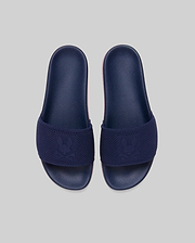 Mens Contrast Sole Knit Slides in navy with a textured knit strap featuring a woven Psycho Bunny skull logo and a subtle pink contrast sole.