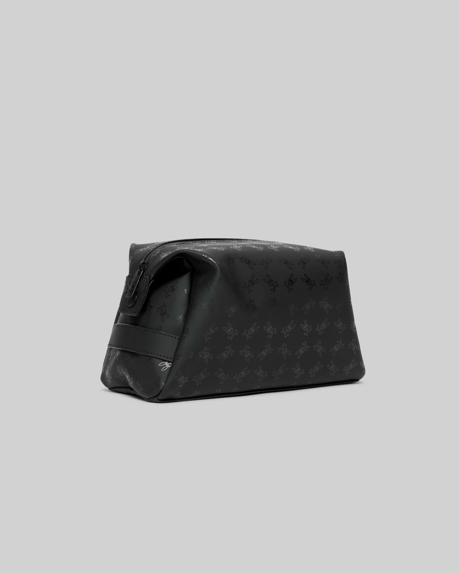 Mens All Over Bunny Toiletry Kit, a sleek black wash bag featuring an all-over tonal Psycho Bunny skull logo pattern and a secure zipper closure.