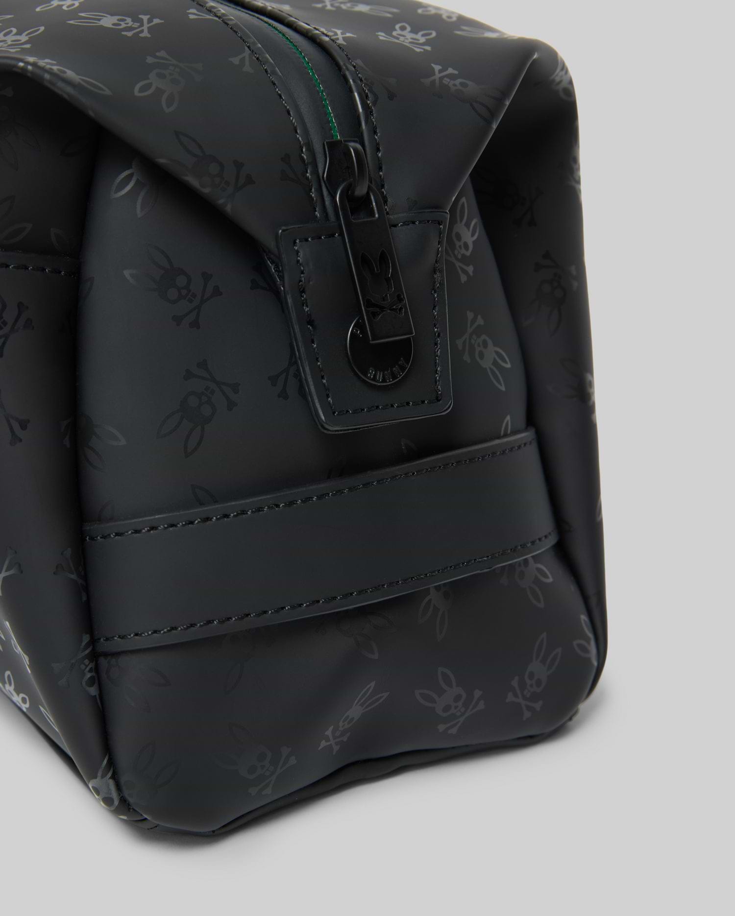 Mens All Over Bunny Toiletry Kit, black with an all-over subtle Psycho Bunny skull logo pattern, smooth texture, top zipper closure with branded pull, and a side strap.