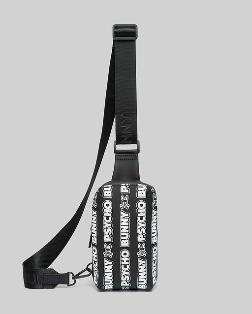 Mens Rubberized Crossbody in black with an all-over white Psycho Bunny text and skull logo pattern, featuring a smooth rubberized texture and an adjustable black woven strap.