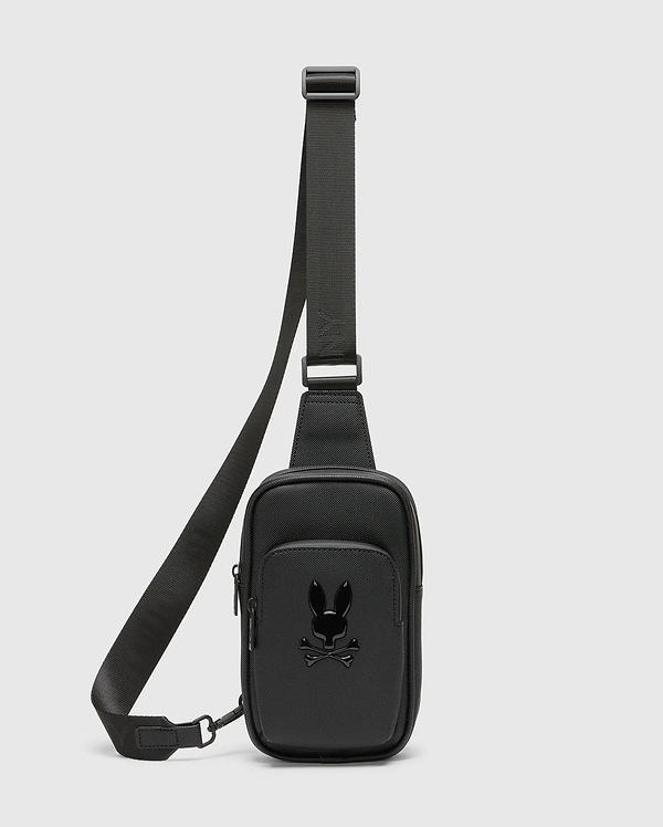 Black Crossbody Bag crafted from a refined Saffiano-style textured material, featuring a prominent glossy black Psycho Bunny skull logo on the front pocket and a durable adjustable strap.