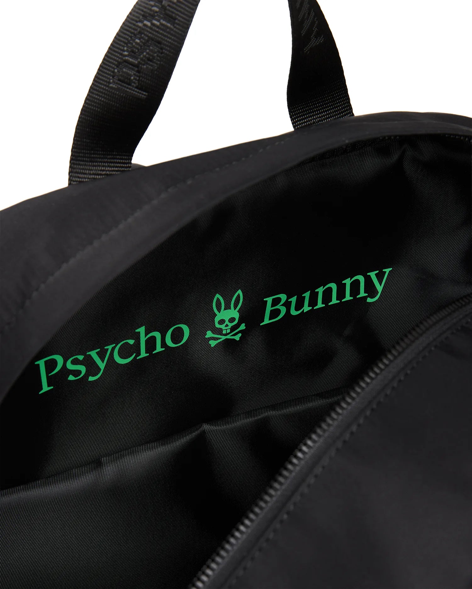 Mens Nylon Backpack in black, featuring a smooth nylon exterior and a bright green Psycho Bunny skull and text logo printed largely on the interior lining.