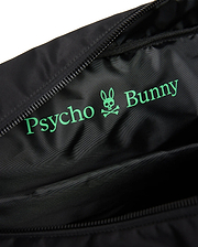 Black Mens Nylon Duffle Bag interior with a large, vibrant green Psycho Bunny text and iconic skull logo printed on the smooth, subtly textured nylon lining, next to a black zipper. (3)