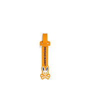 Mens Silicone Strap Luggage Tag in vibrant orange, showcasing bold vertical blue Psycho Bunny text and a prominent white and blue bunny skull logo design.