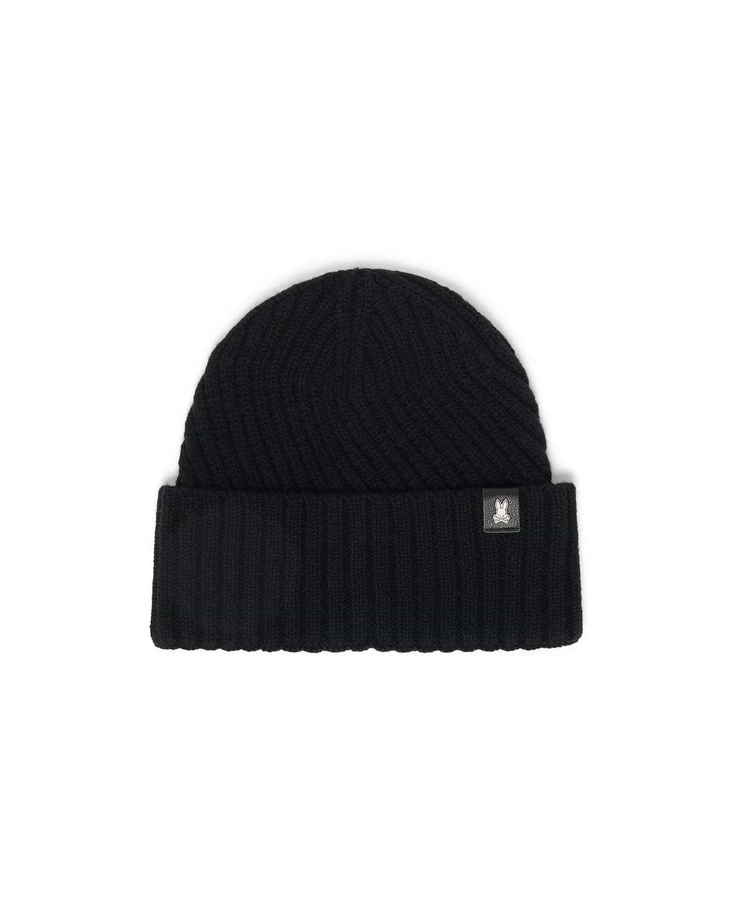 Black Mens Brogan Beanie, a premium ribbed knit beanie featuring a classic folded cuff and a distinctive small white Psycho Bunny skull logo patch on the front.