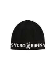 Black knitted Mens Eugene Wordmark Beanie with a ribbed cuff, featuring a large white Psycho Bunny wordmark and iconic bunny skull logo prominently displayed on the front.
