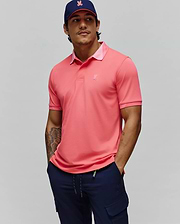 Mens Onyx Sport Polo, a vibrant coral performance polo with a classic fit, features a lighter pink collar underside, ribbed cuffs, and a small tonal embroidered Psycho Bunny skull logo on the left chest.