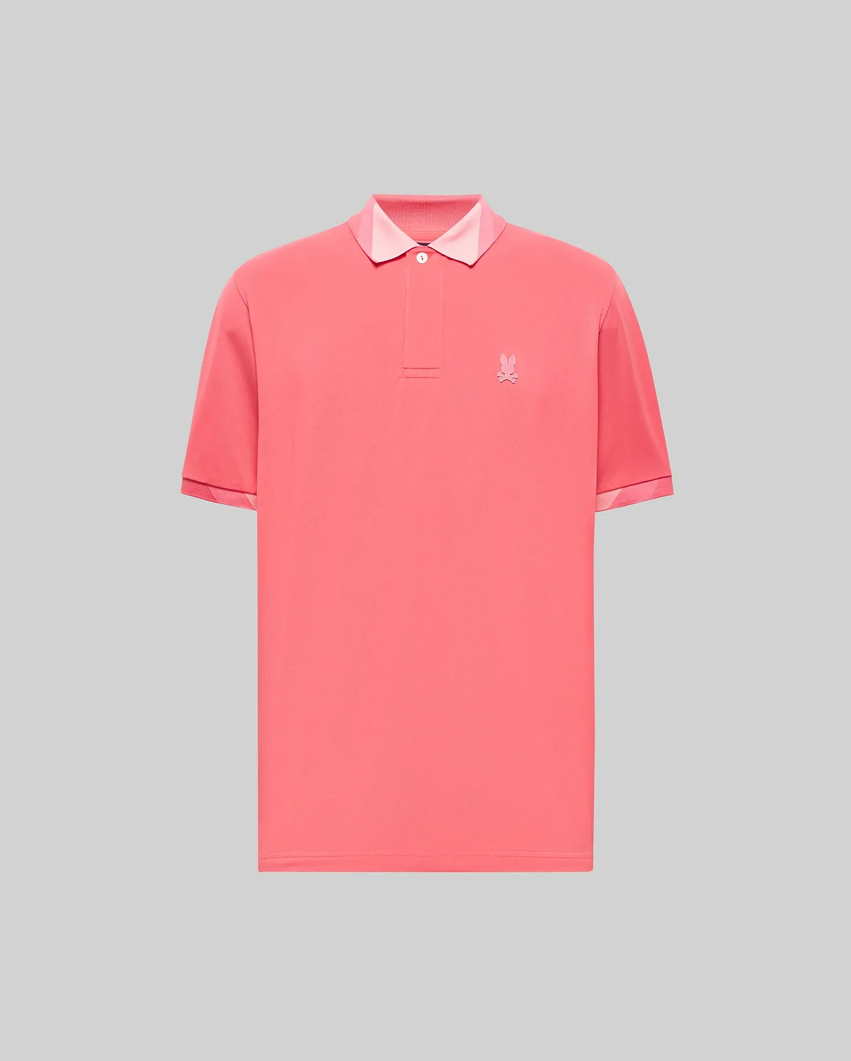 Vibrant coral jersey Mens Onyx Sport Polo with a classic fit, two-button placket, light pink contrast collar lining, and a tonal embroidered Psycho Bunny skull logo on the left chest.