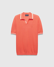 Mens Innis Polo, a vibrant coral knit polo with a V-neck collar and cuffs accented by white stripes, featuring a small embroidered Psycho Bunny skull logo on the left chest. Classic fit. (4)