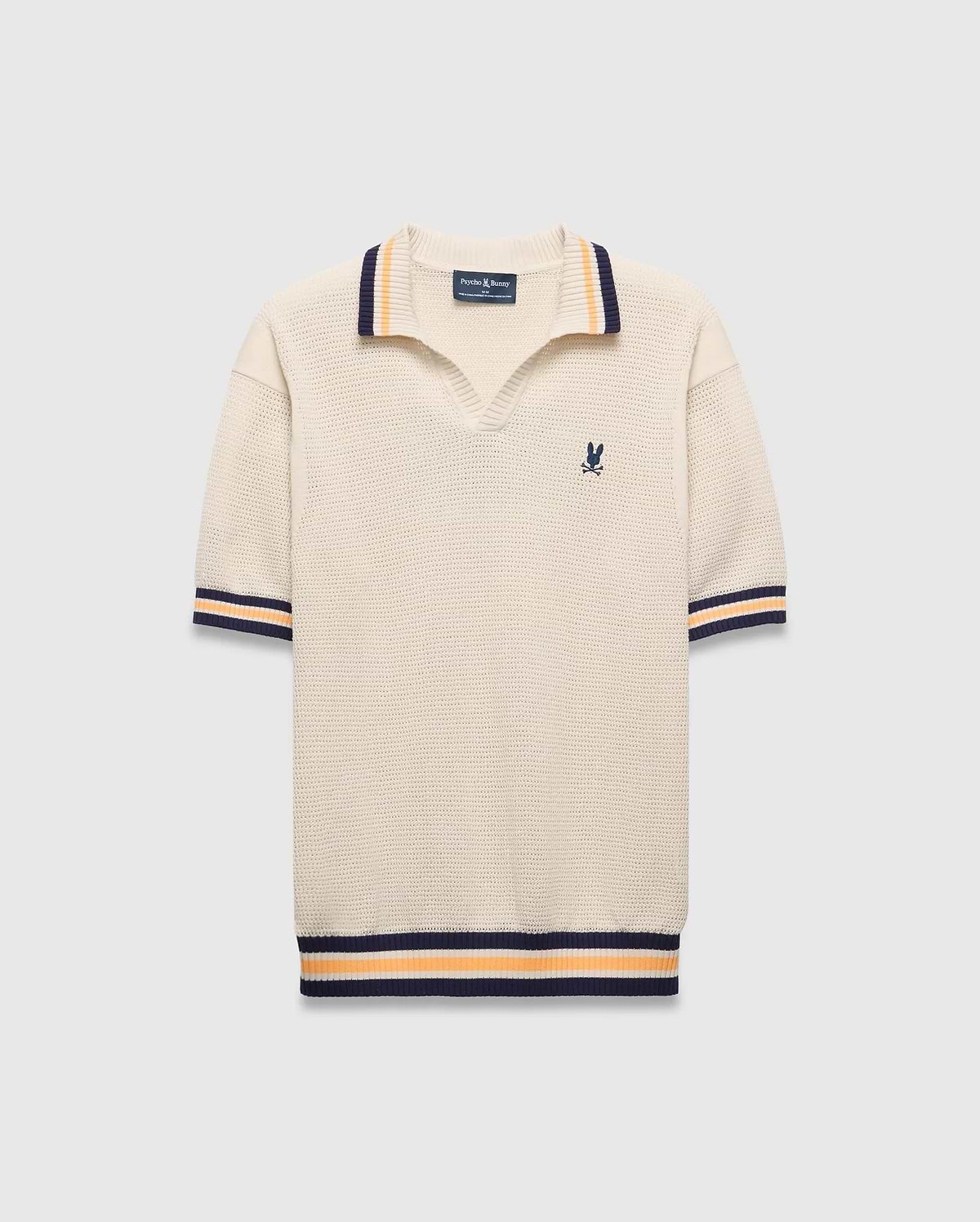 Mens Theros Knit Polo, cream textured knit with a relaxed fit, featuring a V-neck, navy and orange striped ribbed collar, cuffs, and hem, and a small embroidered navy Psycho Bunny skull logo on the left chest.