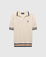 Mens Theros Knit Polo, cream textured knit with a relaxed fit, featuring a V-neck, navy and orange striped ribbed collar, cuffs, and hem, and a small embroidered navy Psycho Bunny skull logo on the left chest.