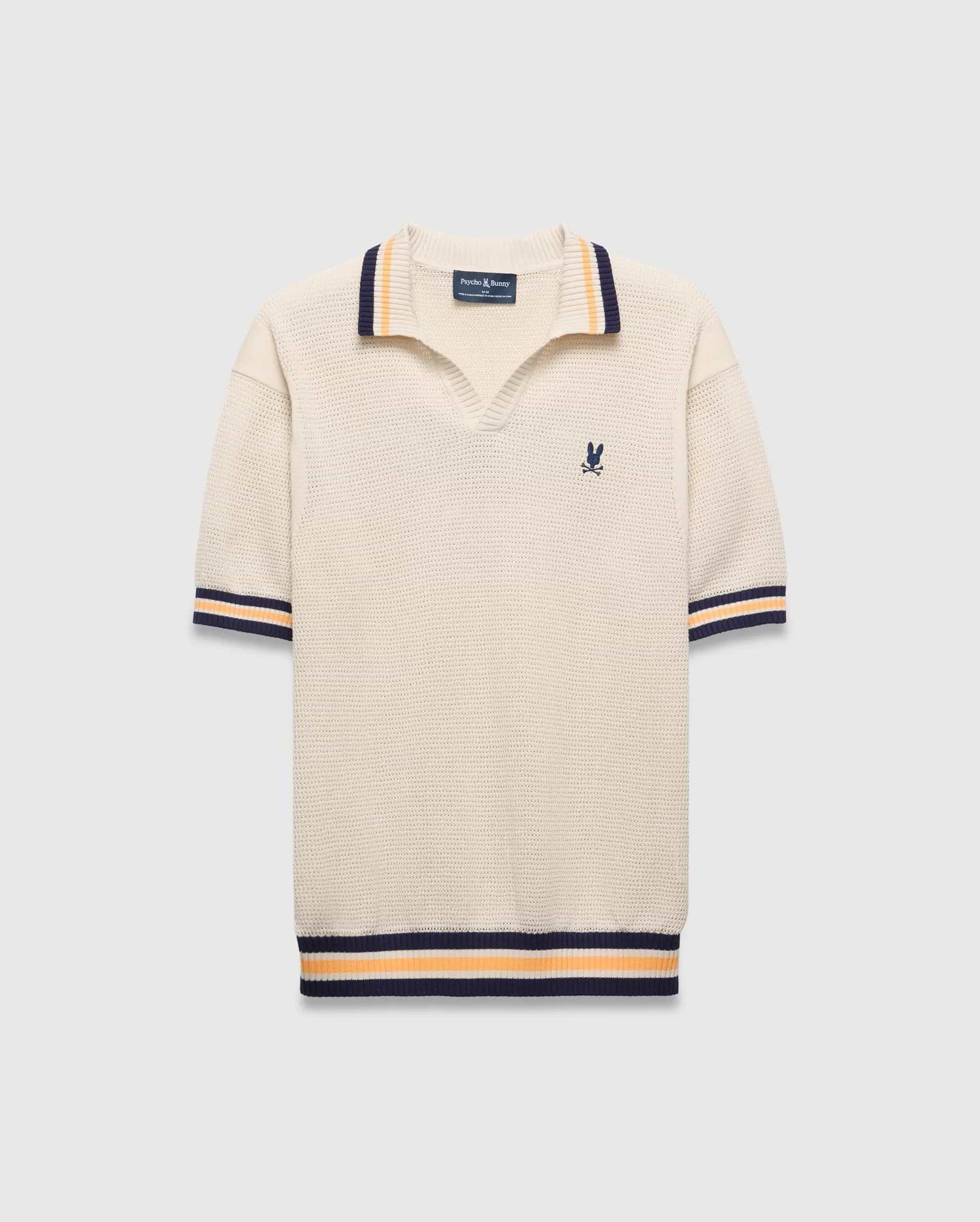 Mens Theros Knit Polo, cream textured knit with a relaxed fit, featuring a V-neck, navy and orange striped ribbed collar, cuffs, and hem, and a small embroidered navy Psycho Bunny skull logo on the left chest.