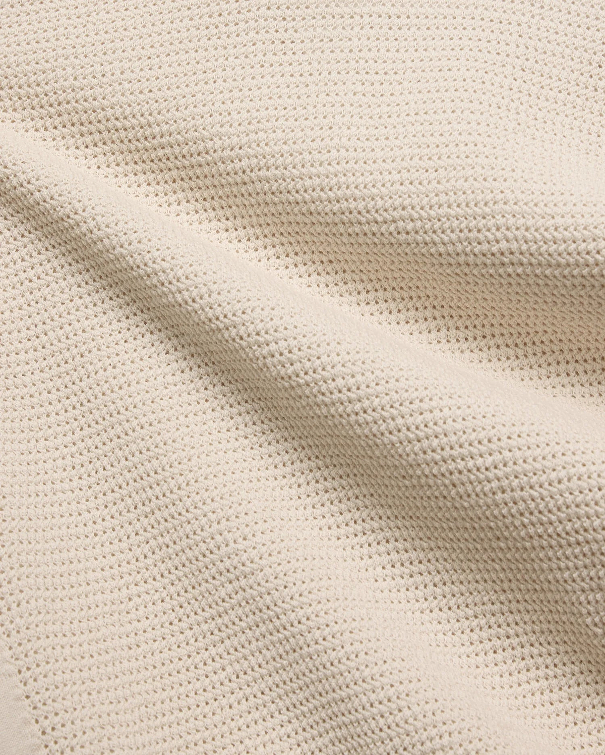 Mens Theros Knit Polo in a luxurious cream hue, showcasing a premium, breathable pique knit fabric with a subtle, sophisticated texture, ideal for refined streetwear.