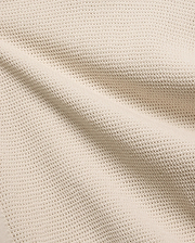 Mens Theros Knit Polo in a luxurious cream hue, showcasing a premium, breathable pique knit fabric with a subtle, sophisticated texture, ideal for refined streetwear.