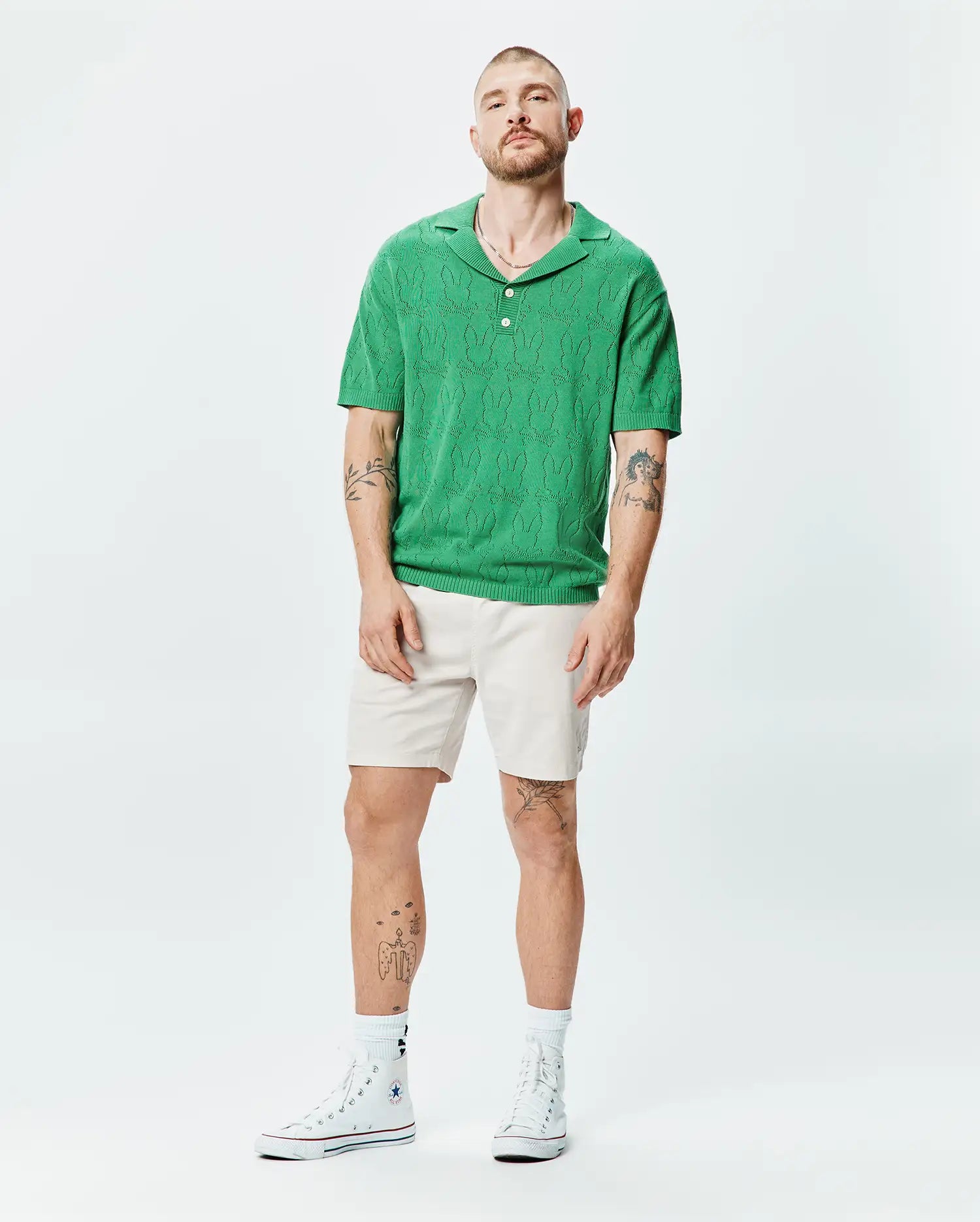 Mens Harold Pointelle All Over Bunny Knit Polo, a vibrant green, classic fit polo with an intricate pointelle knit featuring an all-over Psycho Bunny skull pattern.