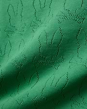 Mens Harold Pointelle All Over Bunny Knit Polo in vibrant emerald green, showcasing a refined all-over pointelle knit pattern of the iconic Psycho Bunny skull logo, creating a textured finish.
