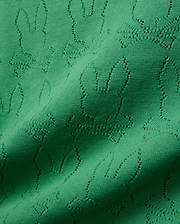 Mens Harold Pointelle All Over Bunny Knit Polo in vibrant emerald green, showcasing a refined all-over pointelle knit pattern of the iconic Psycho Bunny skull logo, creating a textured finish.