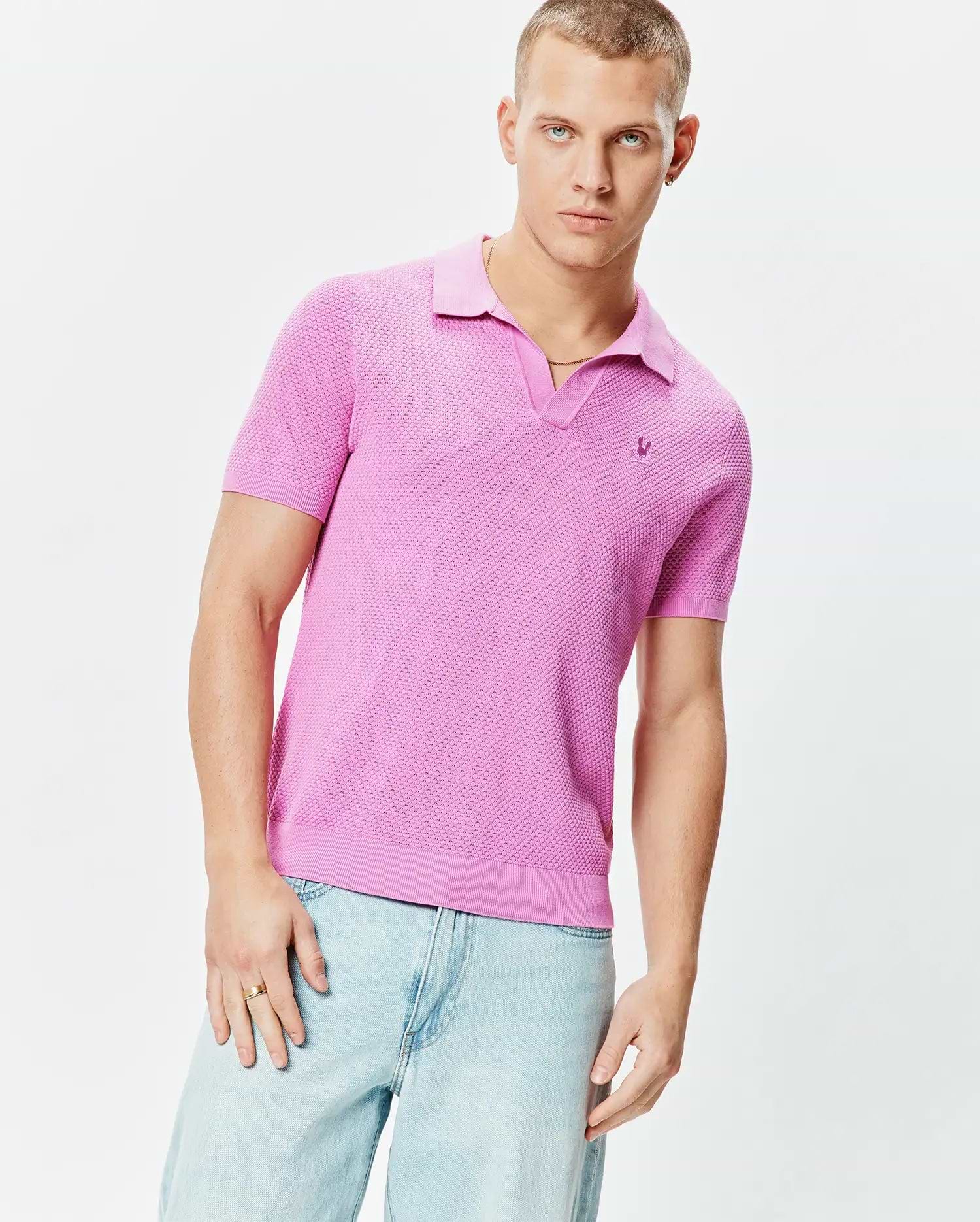 Mens Devon Knit Polo in vibrant pink, featuring a textured knit fabric, classic fit, spread collar, V-neck placket, and a small tonal embroidered Psycho Bunny skull logo on the left chest.
