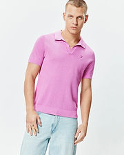 Mens Devon Knit Polo in vibrant pink, featuring a textured knit fabric, classic fit, spread collar, V-neck placket, and a small tonal embroidered Psycho Bunny skull logo on the left chest.