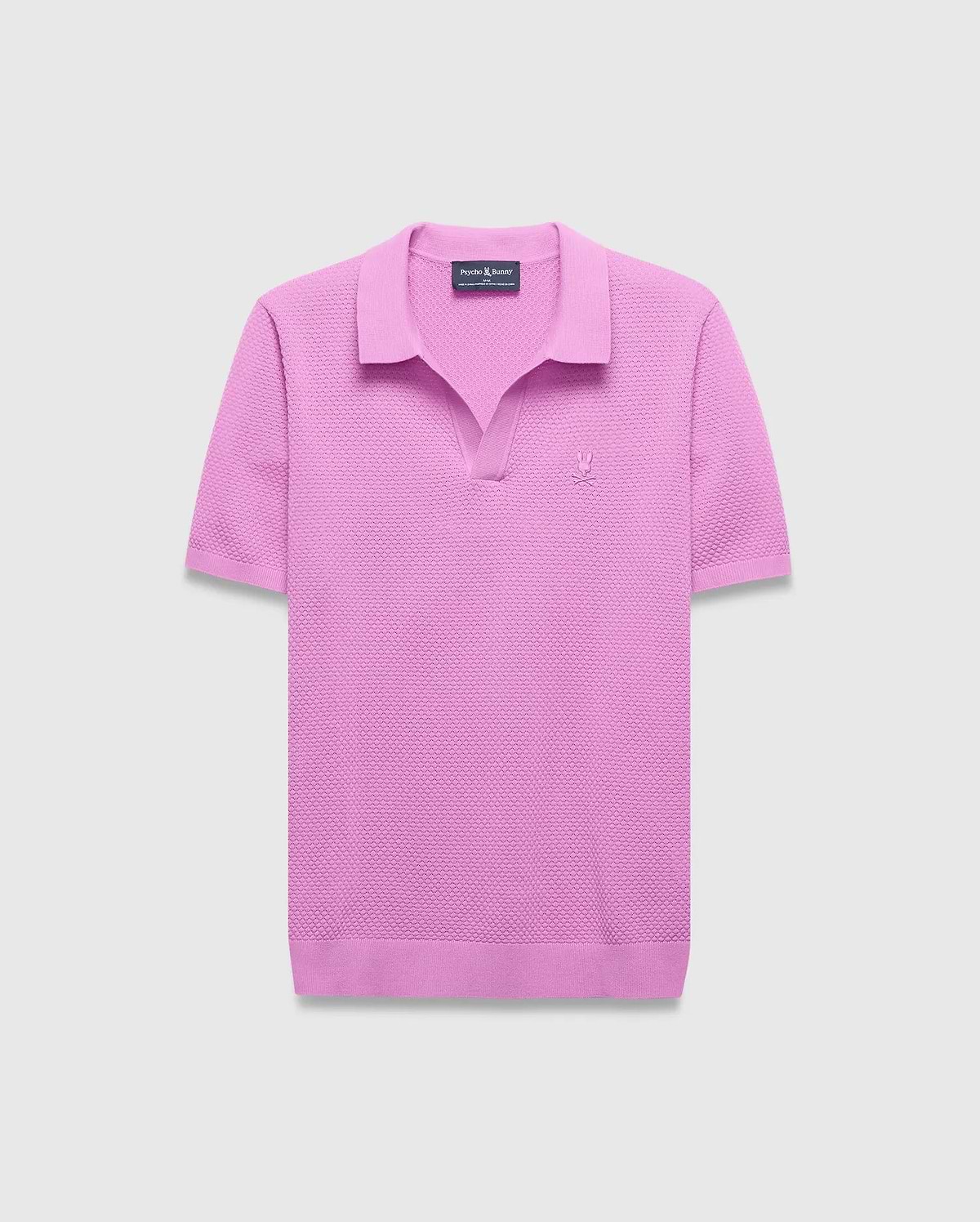 Mens Devon Knit Polo in vibrant pink, featuring a textured knit fabric, classic fit, V-neck placket, and a small tonal embroidered Psycho Bunny skull logo on the left chest.