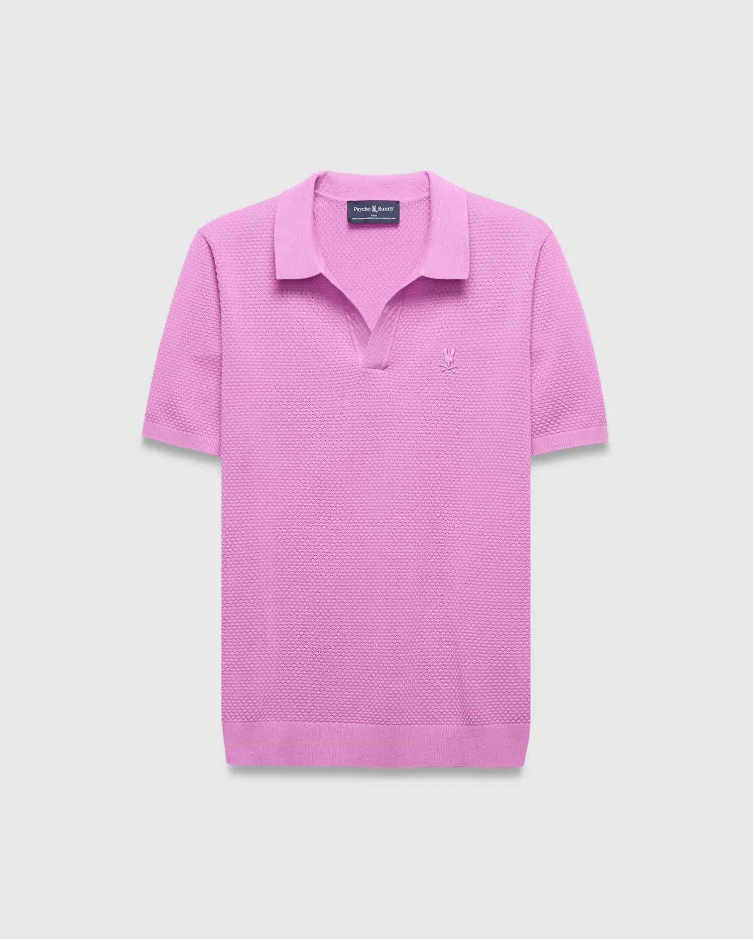 Mens Devon Knit Polo in vibrant pink, featuring a textured knit fabric, classic fit, V-neck placket, and a small tonal embroidered Psycho Bunny skull logo on the left chest.