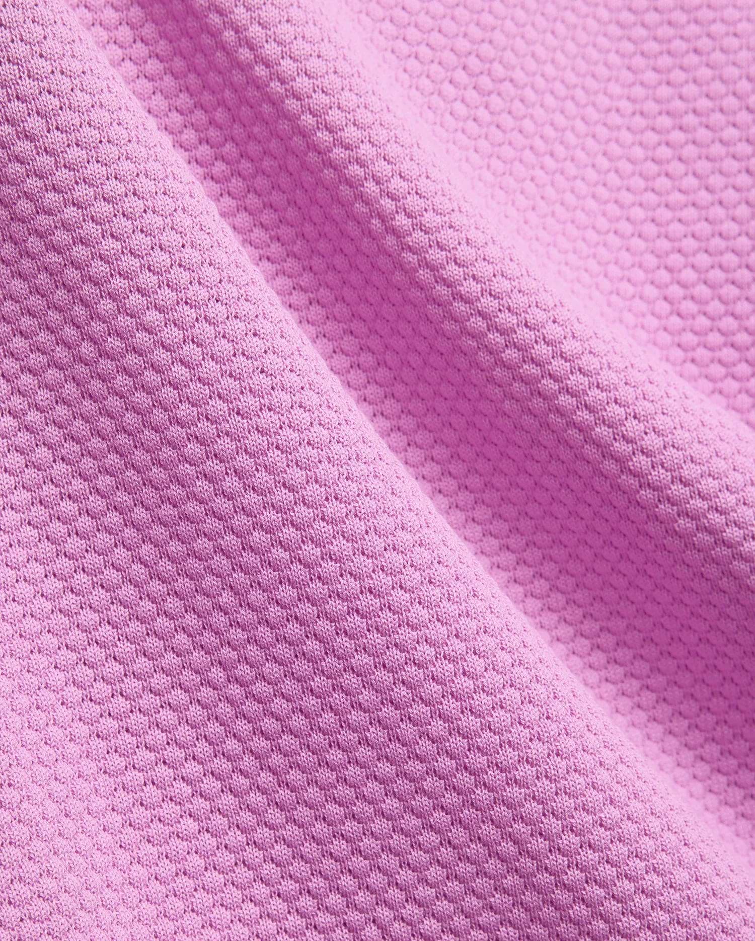 Mens Devon Knit Polo, a premium vibrant fuchsia pink polo shirt crafted from a refined, breathable pique knit fabric, showcasing its distinctive textured pattern.
