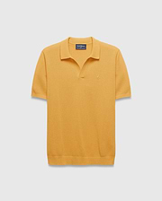 Mens Devon Knit Polo in mustard yellow, featuring a textured waffle knit fabric, classic fit, spread collar, V-neck placket, and a small embroidered Psycho Bunny skull logo on the left chest.