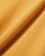 Mens Devon Knit Polo in vibrant gold, featuring a textured pique knit fabric and the signature embroidered Psycho Bunny skull logo on the left chest.