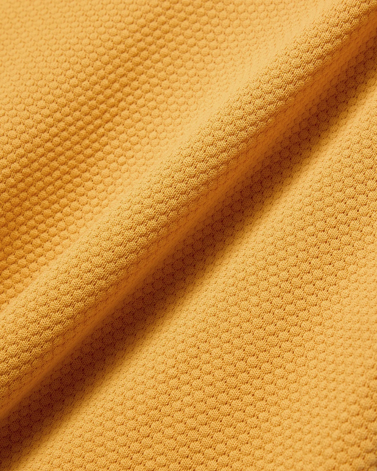 Mens Devon Knit Polo in vibrant gold, featuring a textured pique knit fabric and the signature embroidered Psycho Bunny skull logo on the left chest.