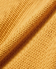 Mens Devon Knit Polo in vibrant gold, featuring a textured pique knit fabric and the signature embroidered Psycho Bunny skull logo on the left chest.