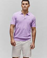 Lavender Mens Devon Knit Polo with a classic fit, textured knit fabric, V-neck, ribbed collar, cuffs, and hem, featuring a small embroidered Psycho Bunny skull logo on the left chest.