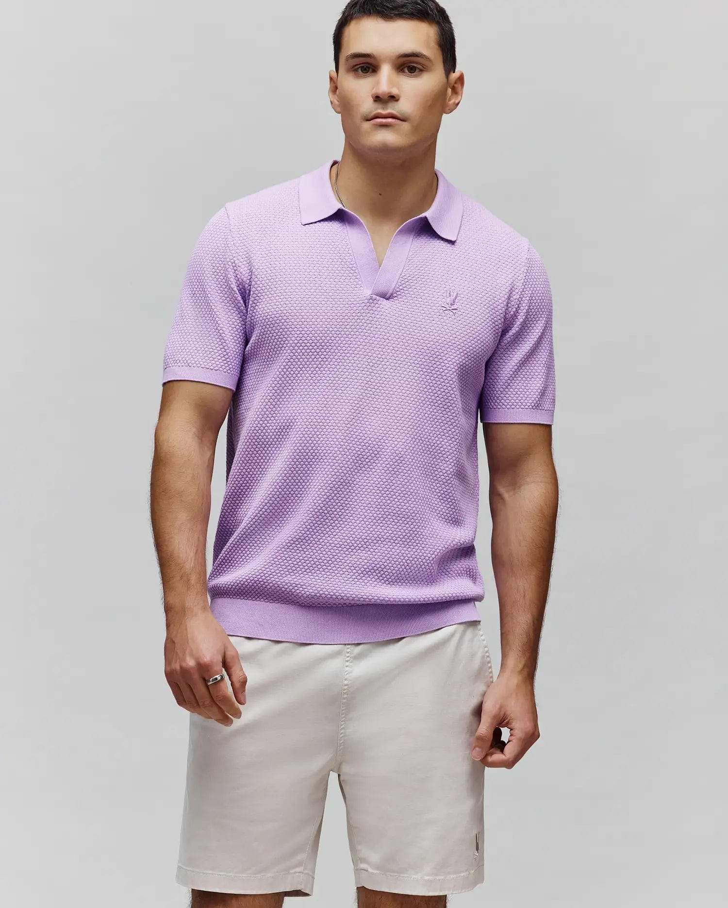 Lavender Mens Devon Knit Polo with a classic fit, textured knit fabric, V-neck, ribbed collar, cuffs, and hem, featuring a small embroidered Psycho Bunny skull logo on the left chest.