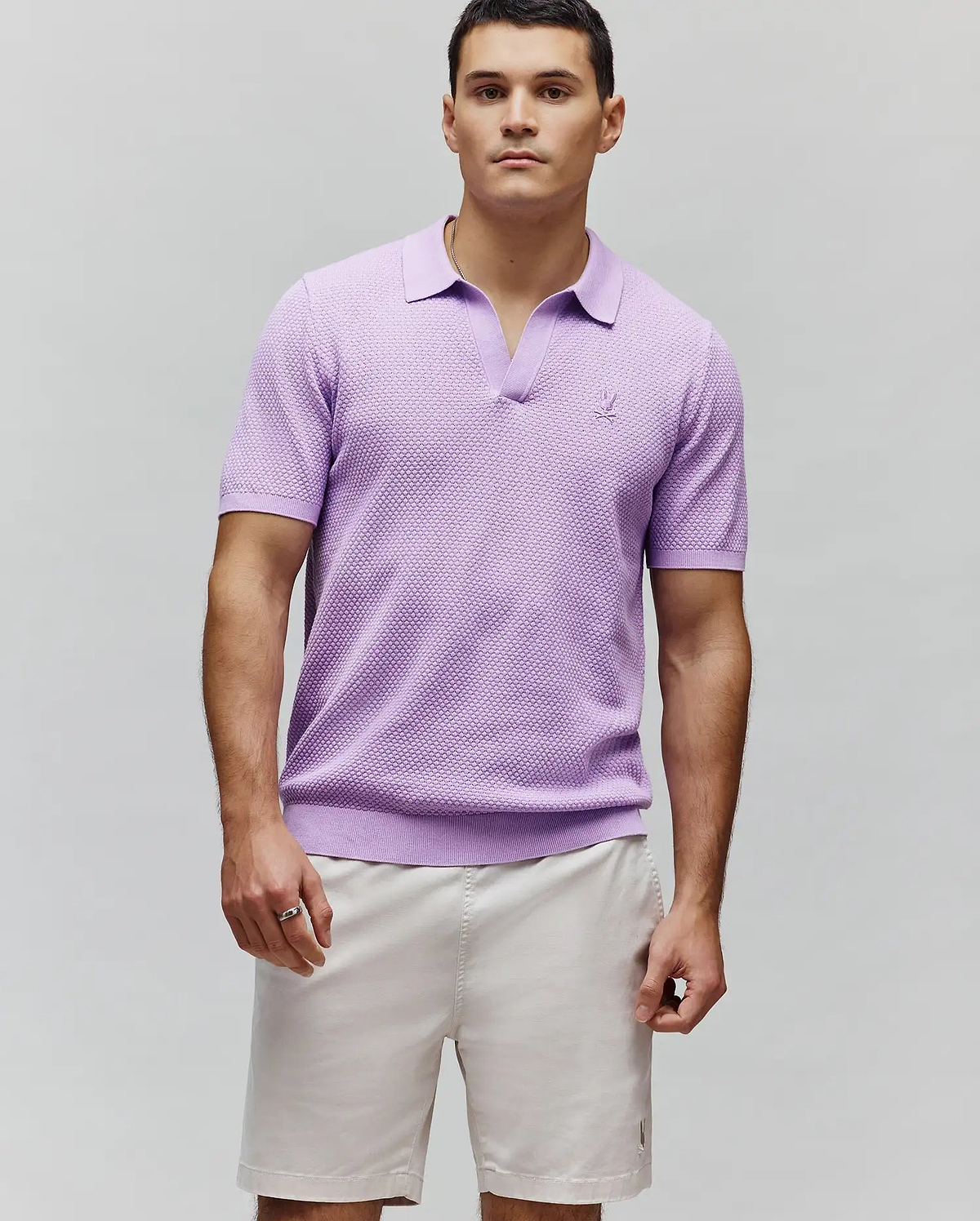 Lavender Mens Devon Knit Polo with a classic fit, textured knit fabric, V-neck, ribbed collar, cuffs, and hem, featuring a small embroidered Psycho Bunny skull logo on the left chest.