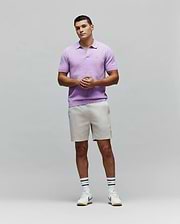 Mens Devon Knit Polo in lavender, featuring a textured knit fabric, open collar, ribbed hem, and a small embroidered Psycho Bunny skull logo on the left chest.