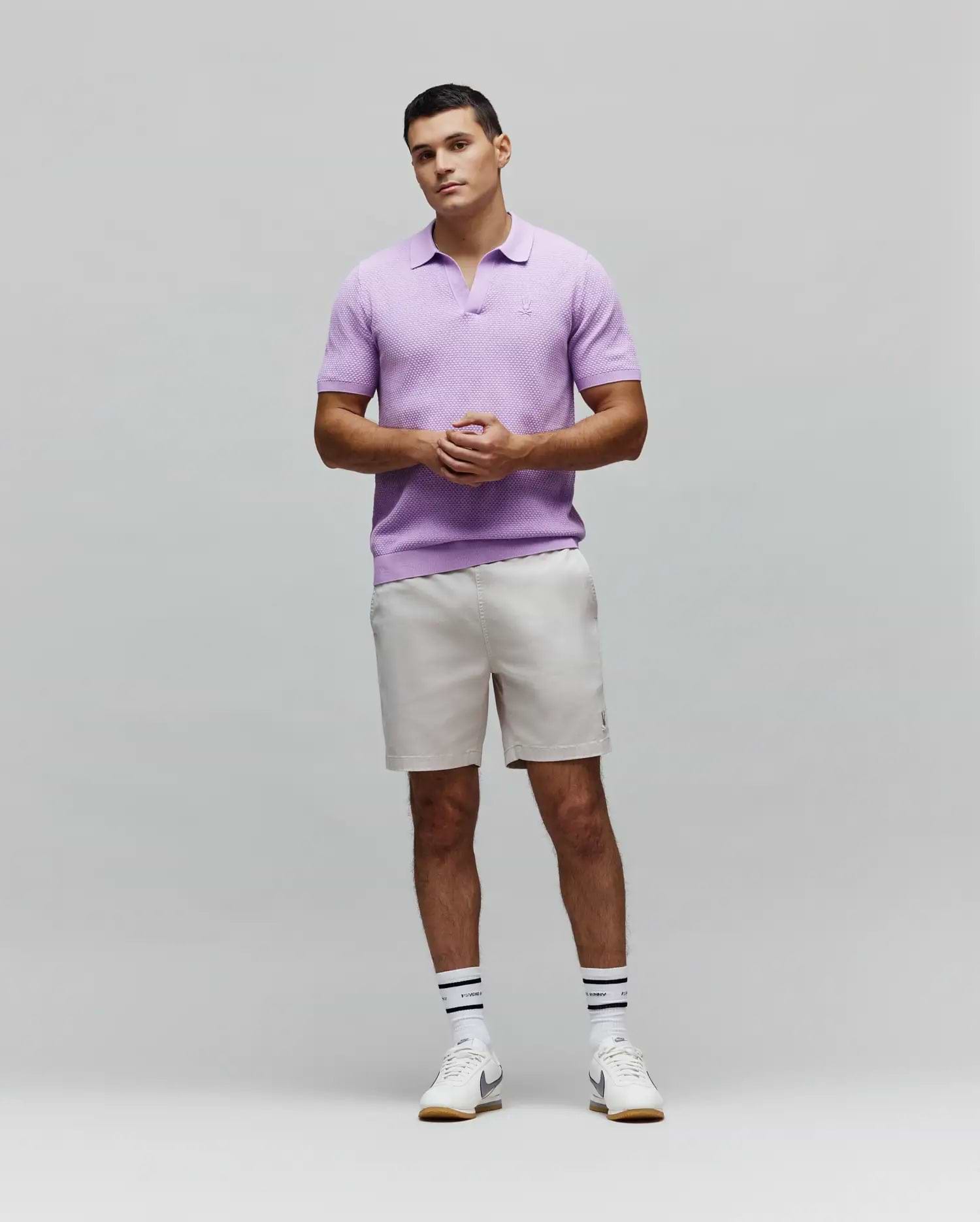Mens Devon Knit Polo in lavender, featuring a textured knit fabric, open collar, ribbed hem, and a small embroidered Psycho Bunny skull logo on the left chest.