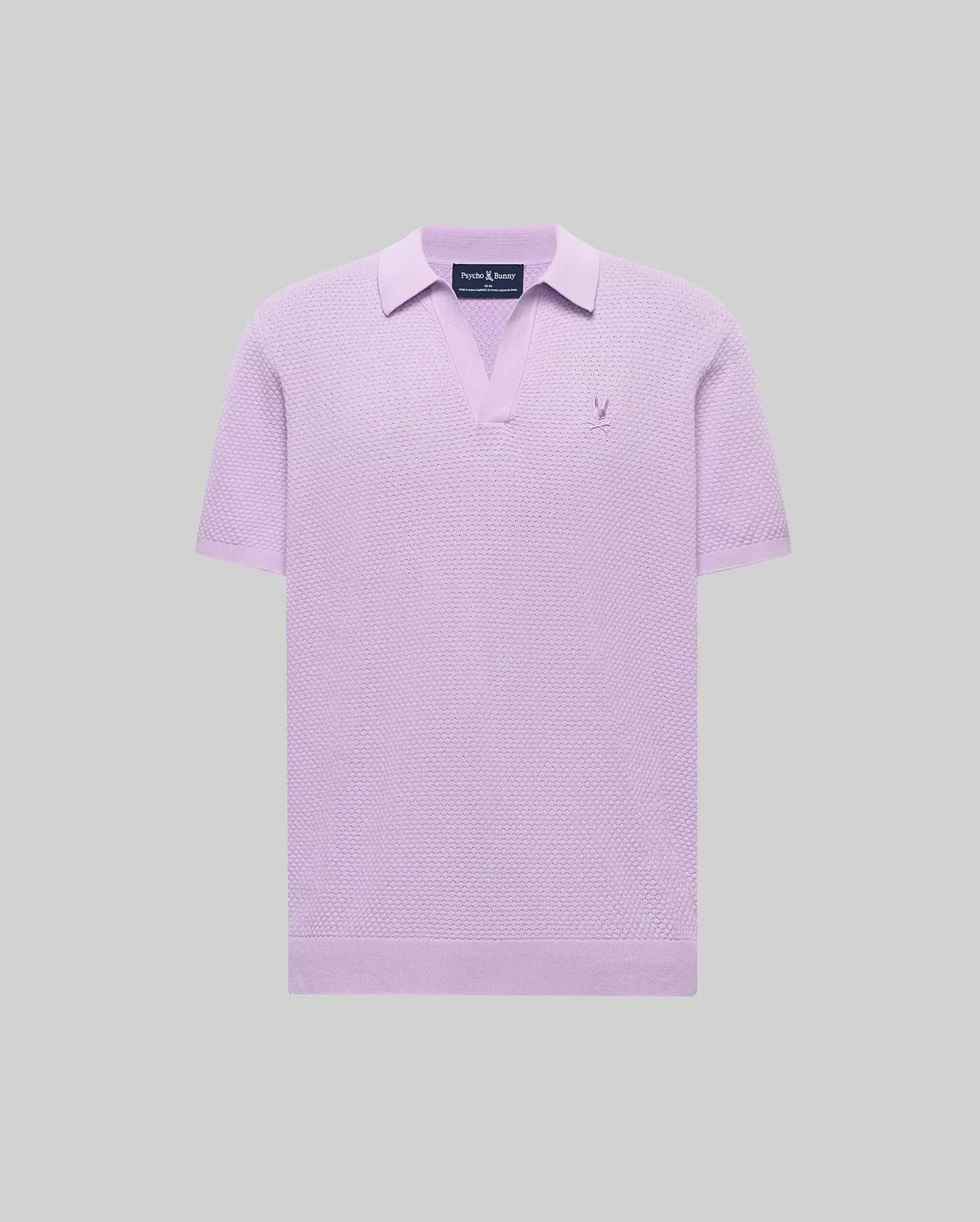 Mens Devon Knit Polo in lavender, featuring a textured knit fabric, open V-neck collar, and a small embroidered Psycho Bunny skull logo on the left chest.
